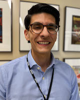 A headshot of Gregory Constantine in a blue shirt.