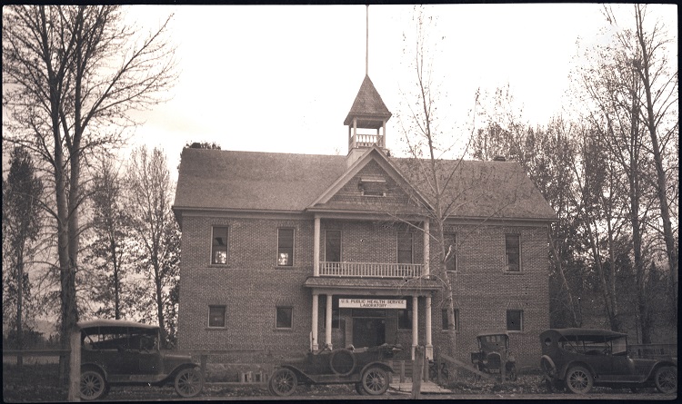The schoolhouse turned laboratory, circa 1921. Notice the U.S. Public Health Service Laboratory sign. This photo was taken before a fence and animal cages were built. Image: Rocky Mountain Laboratories, 196