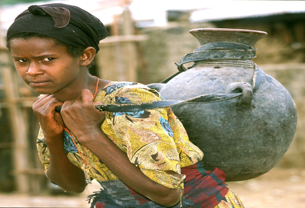 Ethiopian girl carries jug of water. Outbreaks of hepatitis E can occur in areas where there is limited access to clean water.