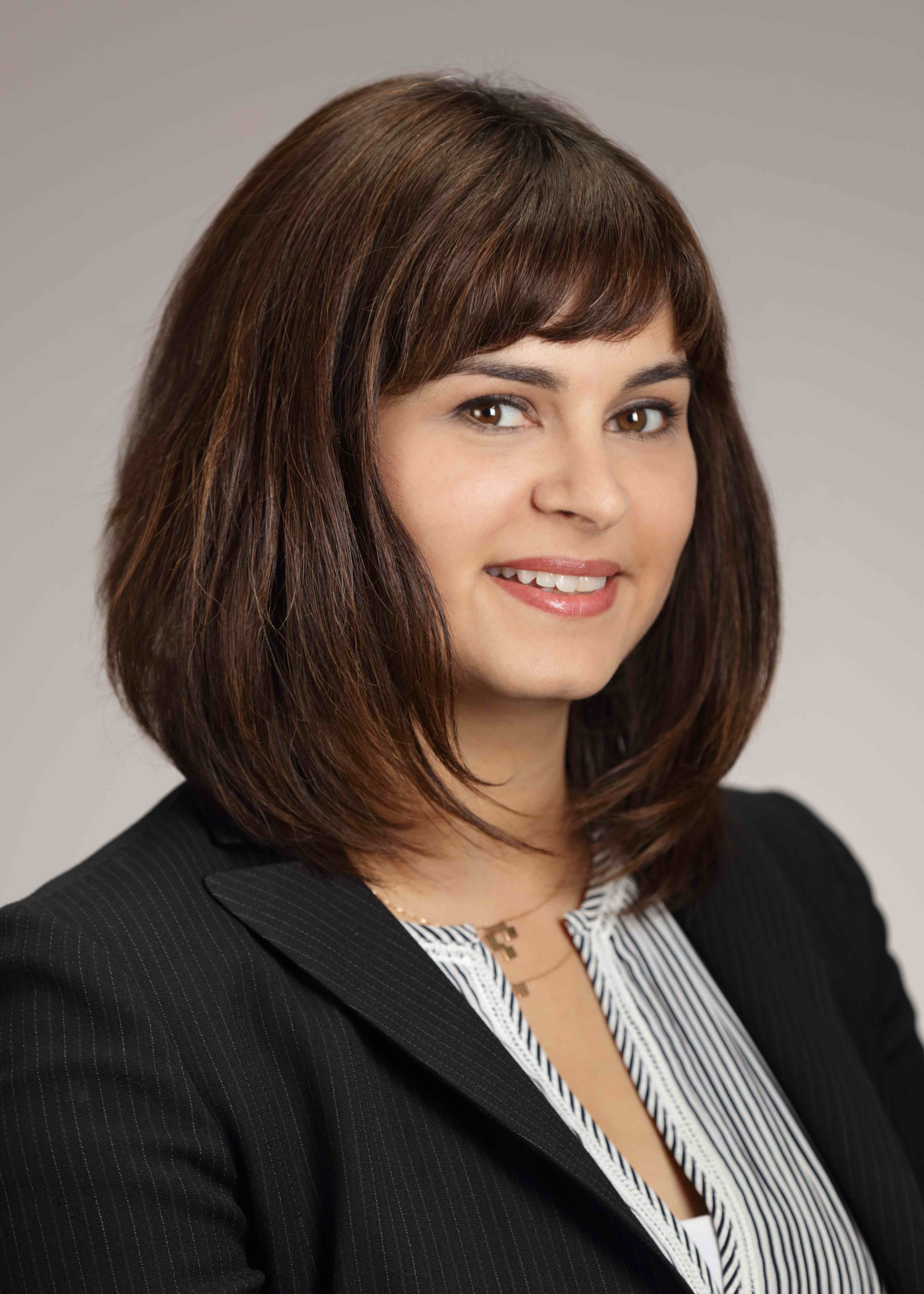 A headshot of Paneez Khoury in a lab coat.