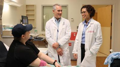 Researchers from the National Institutes of Health talk with a study participant at the NIH Clinical Center.