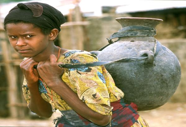 Ethiopian girl carries jug of water. Outbreaks of hepatitis E can occur in areas where there is limited access to clean water.