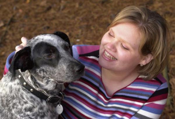 Photo of woman and dog: NIAID pox-vector technology has been used in vaccines to protect companion animals from infectious disease.