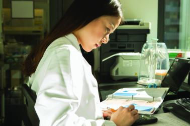 Scientist using a calculator