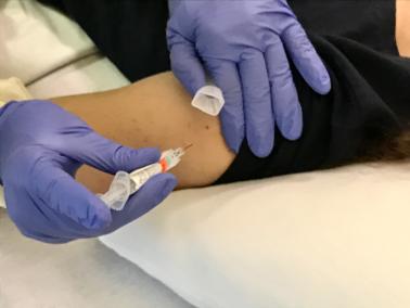 Volunteer in trial of candidate universal flu vaccine receives injection