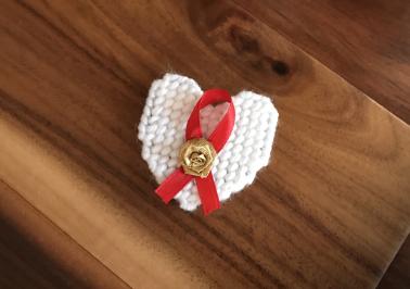 Red AIDS Awareness Ribbon and white Pin of Remembrance