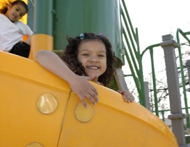 Girls on playground slide.