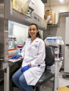 Sarah Cook, postbac at the Laboratory of Immune System Biology, poses for a photo in the lab