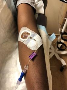 A healthy volunteer receives an intravenous infusion of mAb114—an experimental treatment for Ebola virus disease
