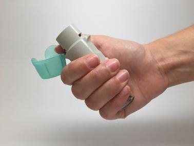 Photo of hand holding an inhaler