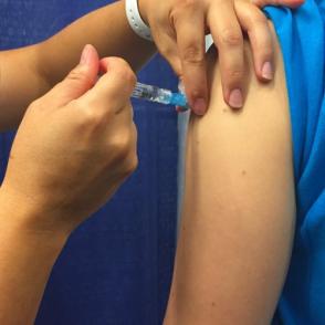 A person receives a flu shot