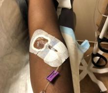 Photo of healthy volunteer receiving experimental Ebola treatment