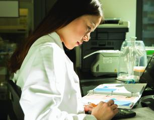 Scientist using a calculator