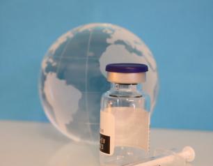 A Syringe, a Vaccine Bottle, and glass Globe