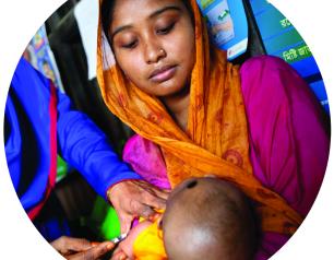 woman holding her baby while baby gets vaccinated