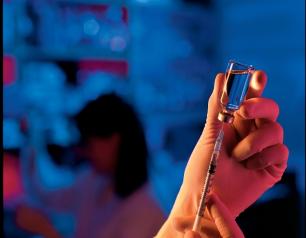 hands holding vaccine vial