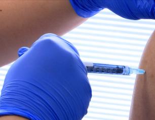 close up of vaccine needle in arm