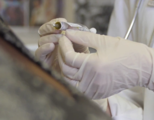 A researcher prepares to administer an investigational vaccine to a clinical trial participant.