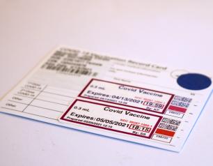 White card with black text recording two doses of COVID-19 vaccine.