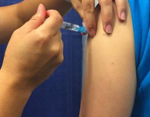 A person receives a flu shot