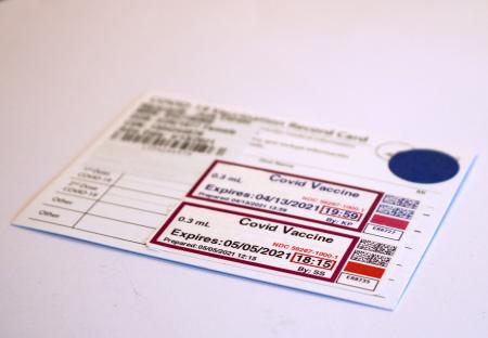 White card with black text recording two doses of COVID-19 vaccine.