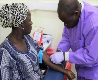 Investigator Collects a Blood Sample